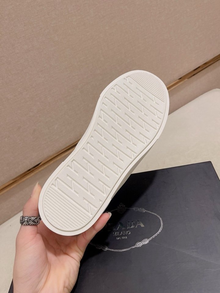Prada Triangle-Patch Slip-On Shoes — detail